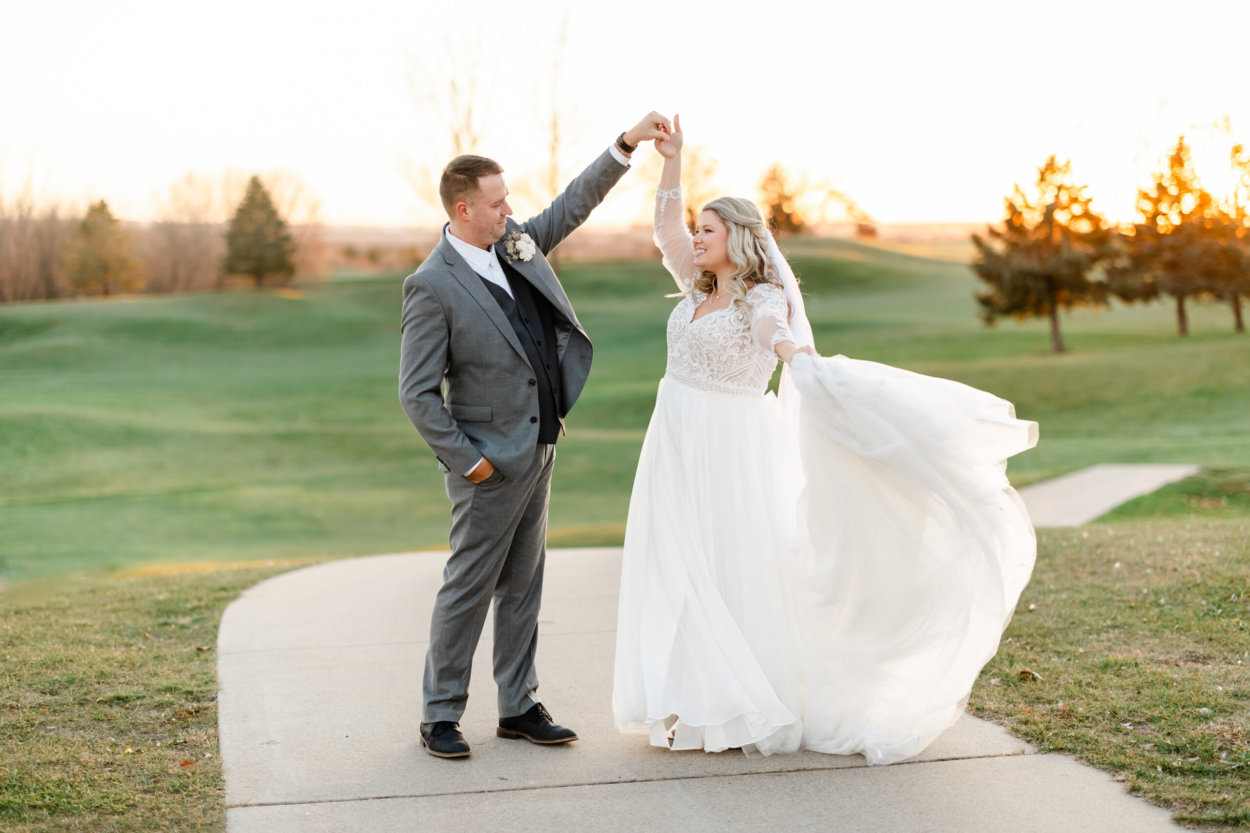 Groom spinning bride off into the sunset at woodhaven venue minnesota