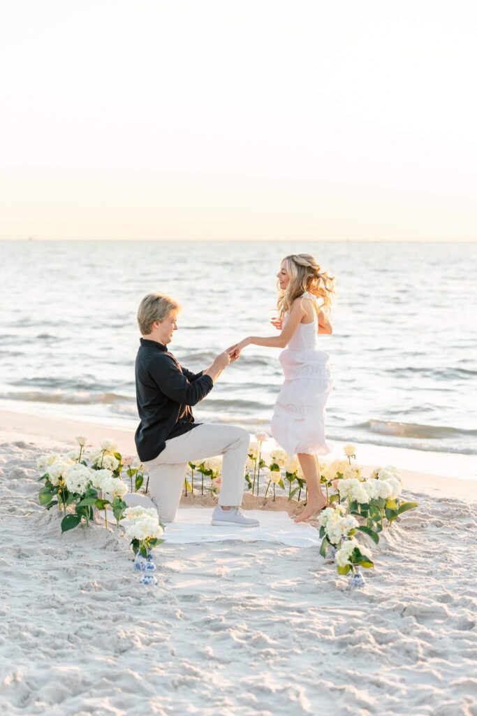 man proposing to woman who is excited by naples photographer