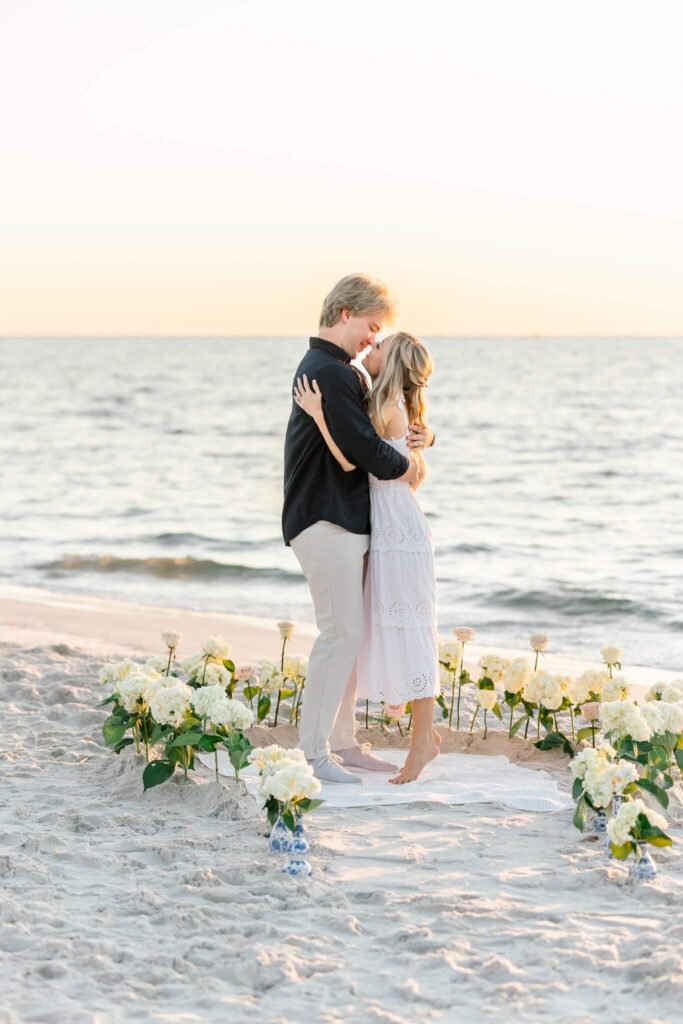 couple kissing on the beach at surprise proposal planned by one of naples photographers