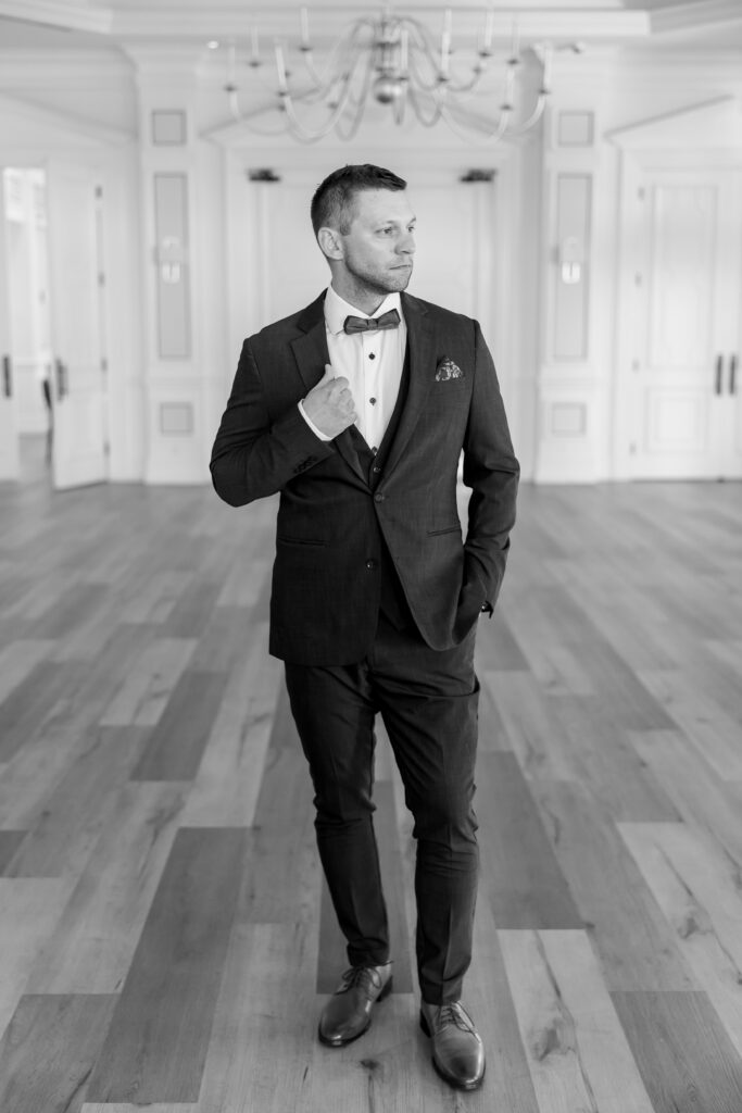 groom posing in black and white at the club at the strand strand boulevard naples fl