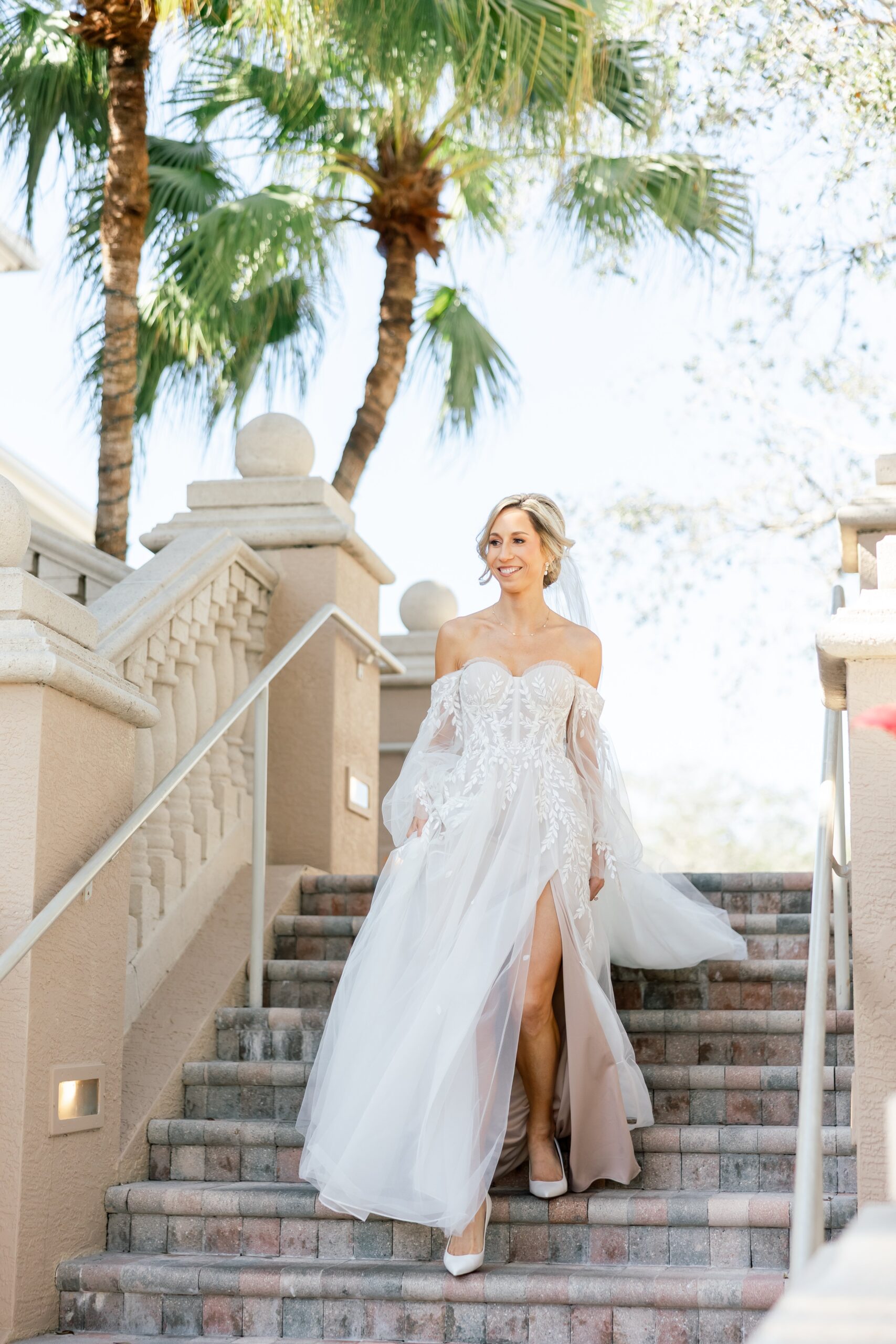 bride walking down stairs at the club at the strand strand boulevard naples fl