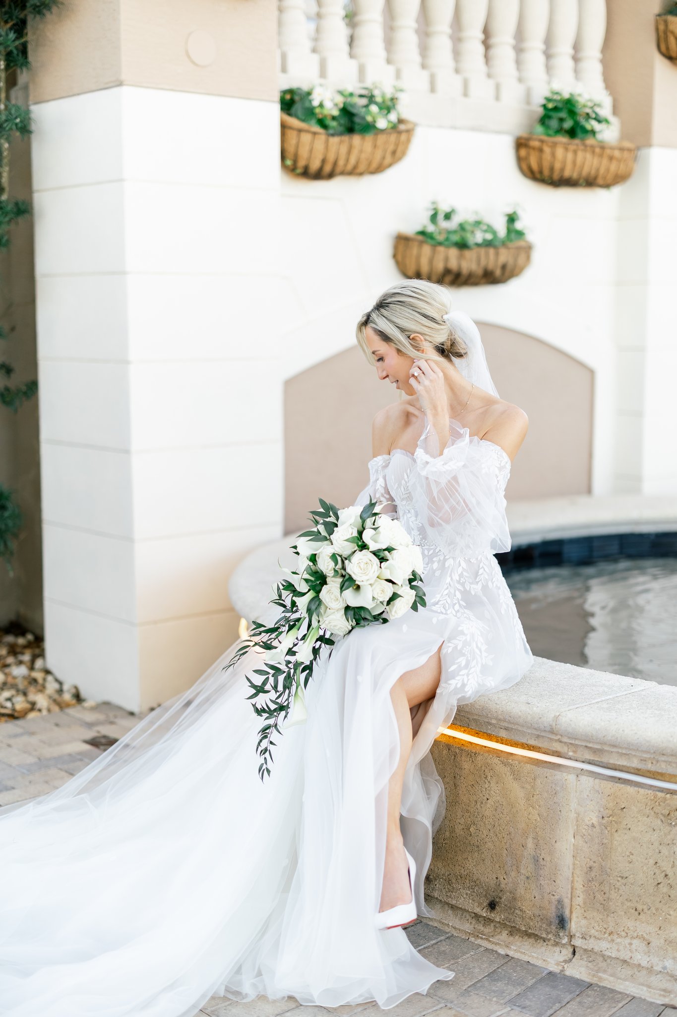bride sitting on fountain at club at the strand