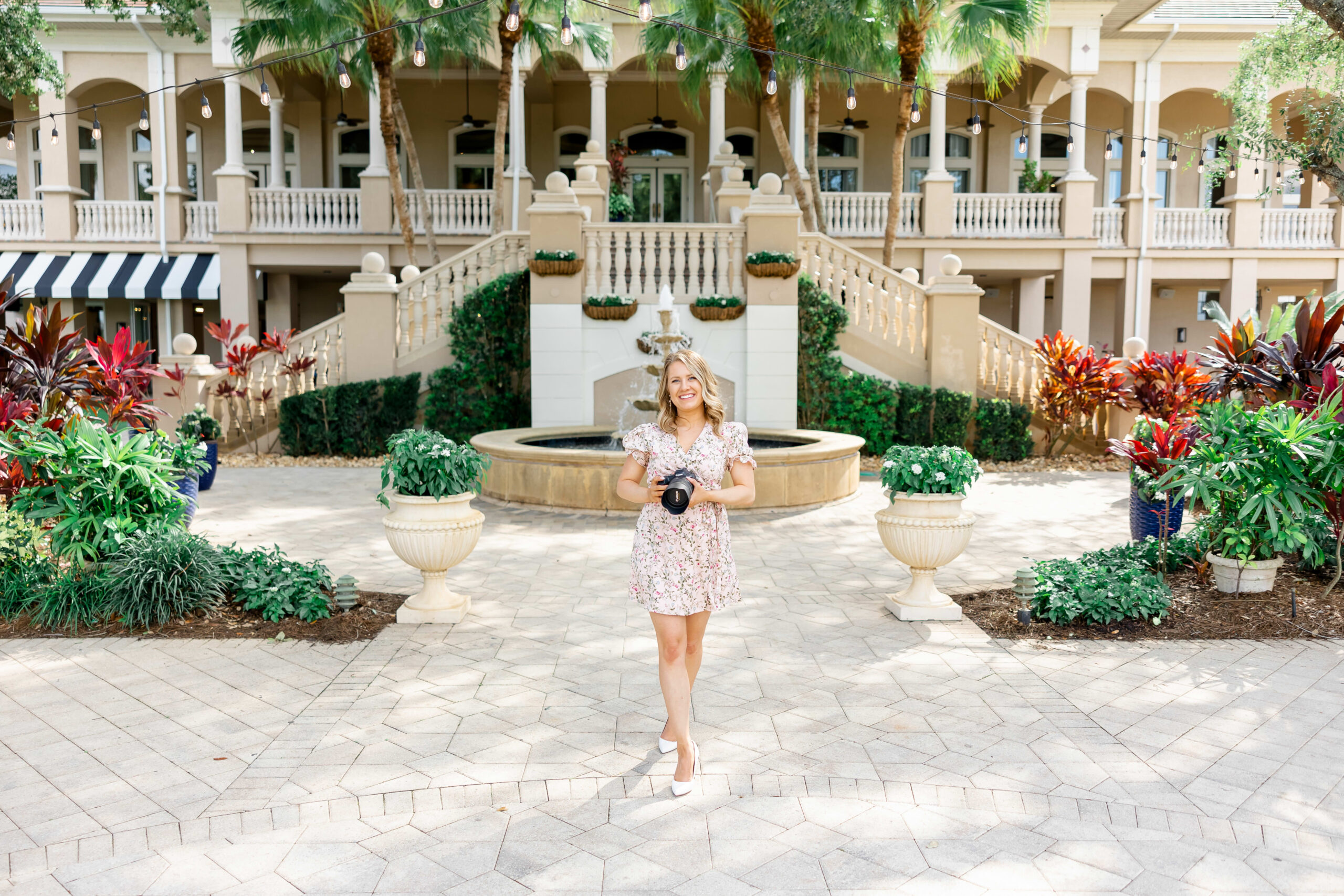 Lindsey White posing at a naples wedding venue to show being a wedding photographer