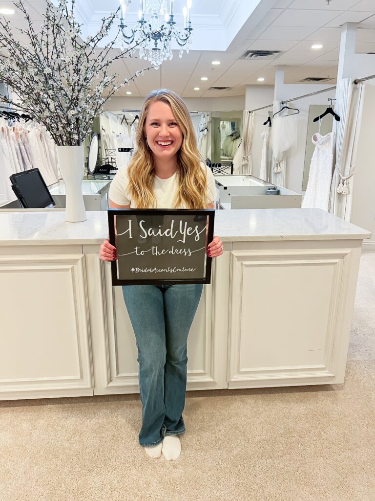 woman holding a yes to the dress sign