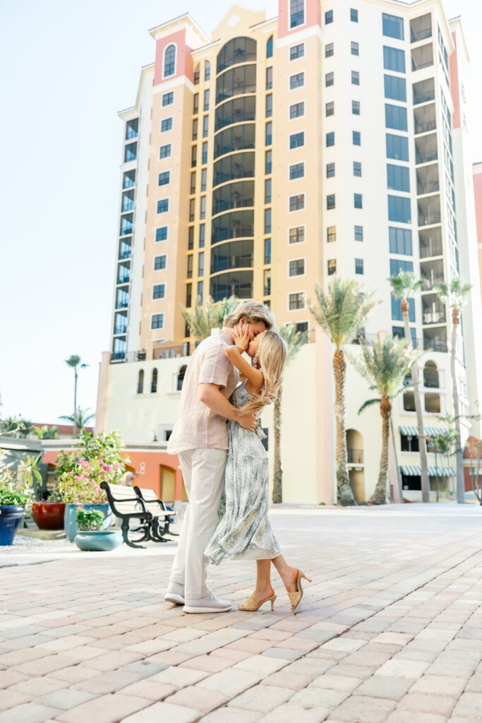 couple kissing in front of building at cape harbour marina cape coral fl