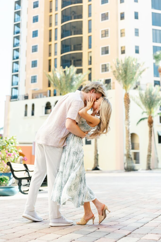 couple kissing in front of building at cape harbour marina cape coral fl
