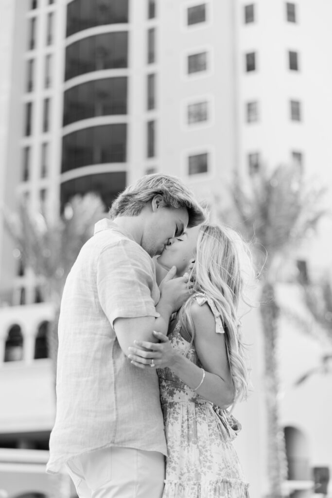 couple kissing in black and white at cape harbour marina cape coral fl
