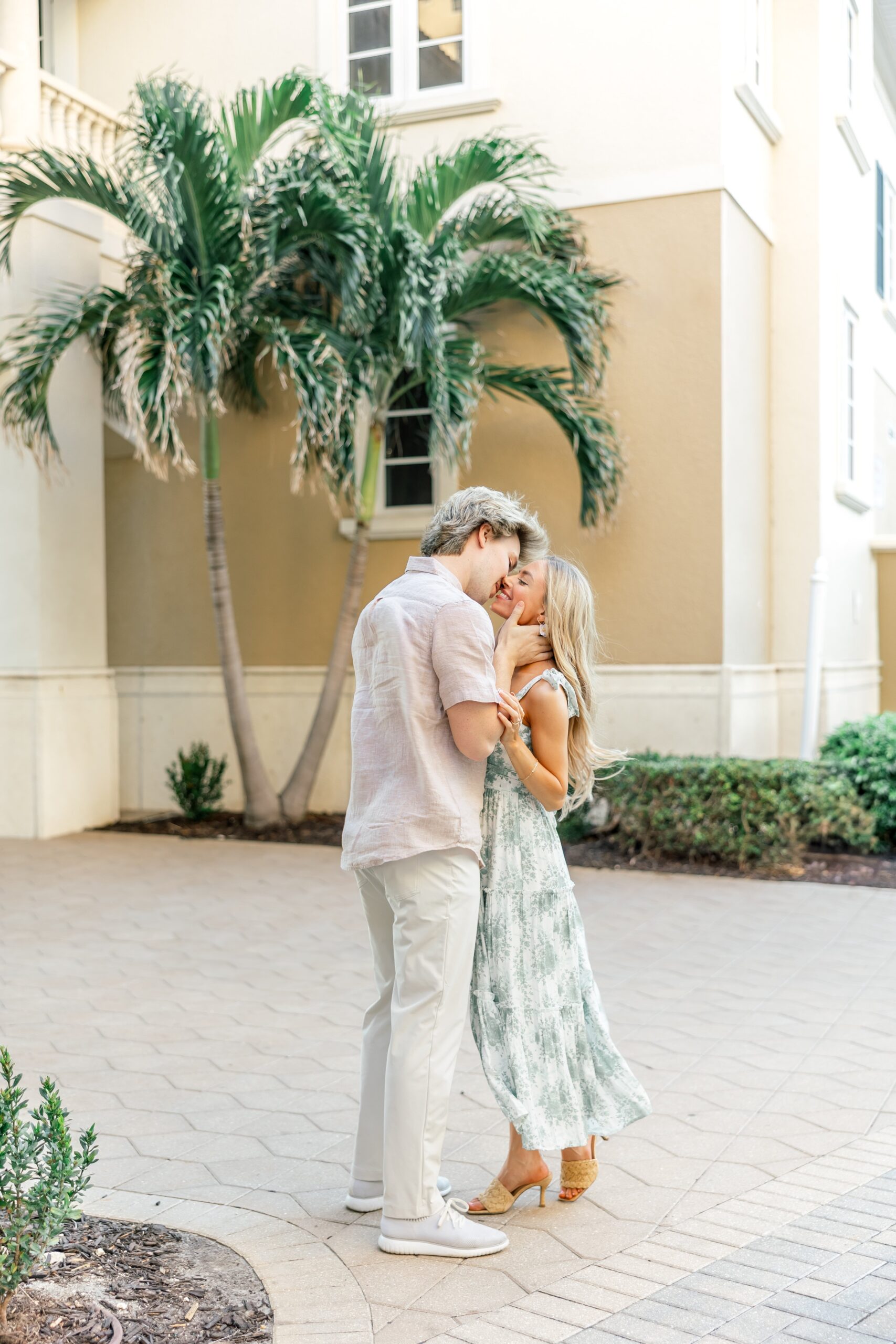 couple smiling and kissing at cape harbour marina cape coral fl
