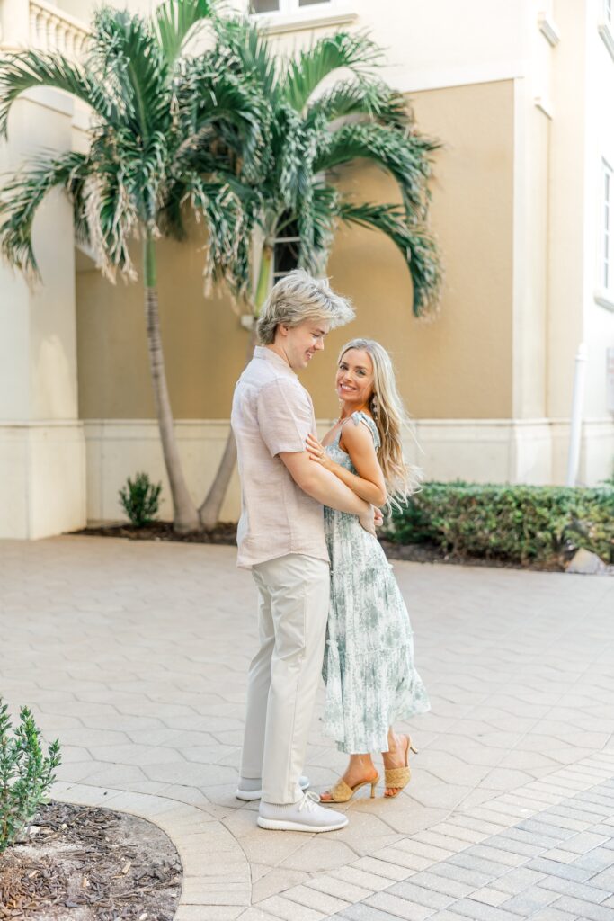 couple smiling for engagement photos at cape harbour marina cape coral fl
