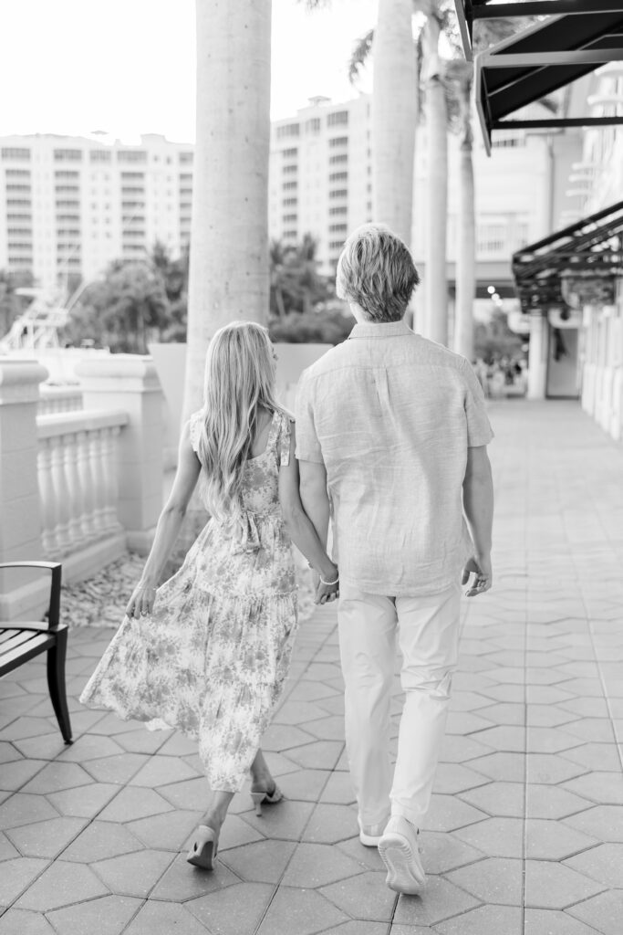 black and white image of couple walking at cape harbour