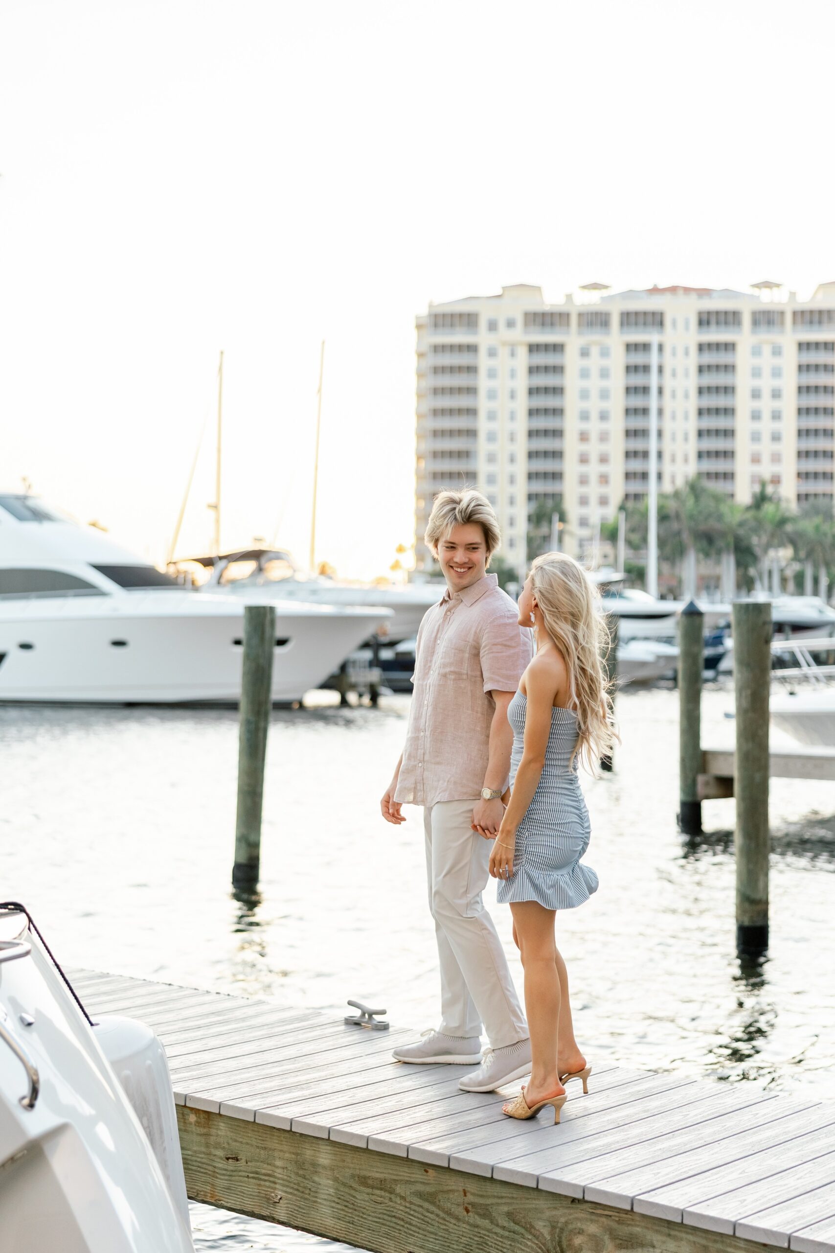 couple walking at dock at cape harbour cape coral fl
