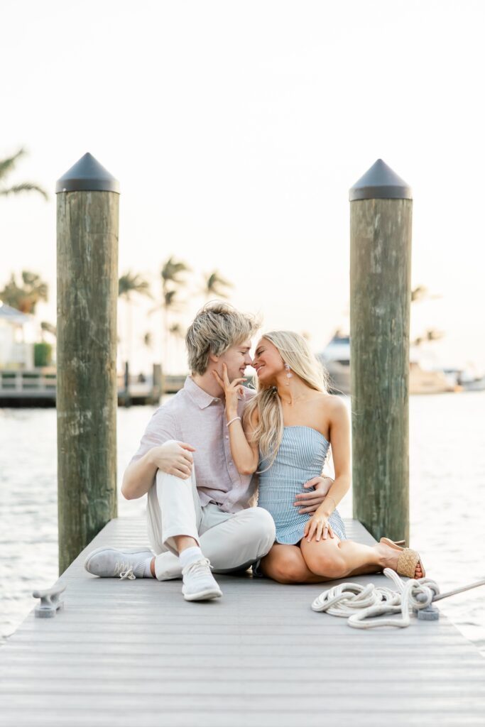 couple sitting and kissing on dock at cape harbour cape coral fl